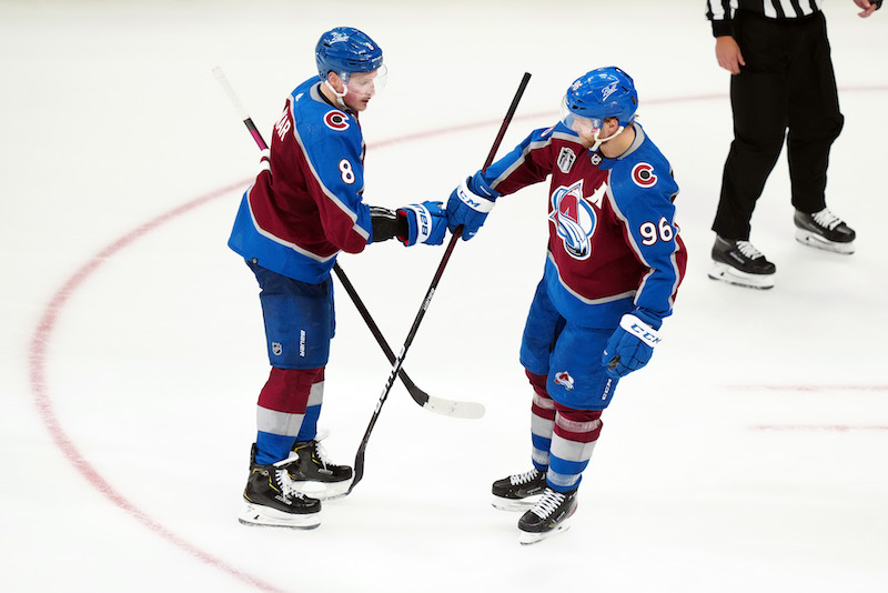 Colorado Avalanche defenseman Cale Makar is congratulated after scoring a goal against the Tampa Bay Lightning during the third period of game two of the 2022 Stanley Cup Final at Ball Arena.