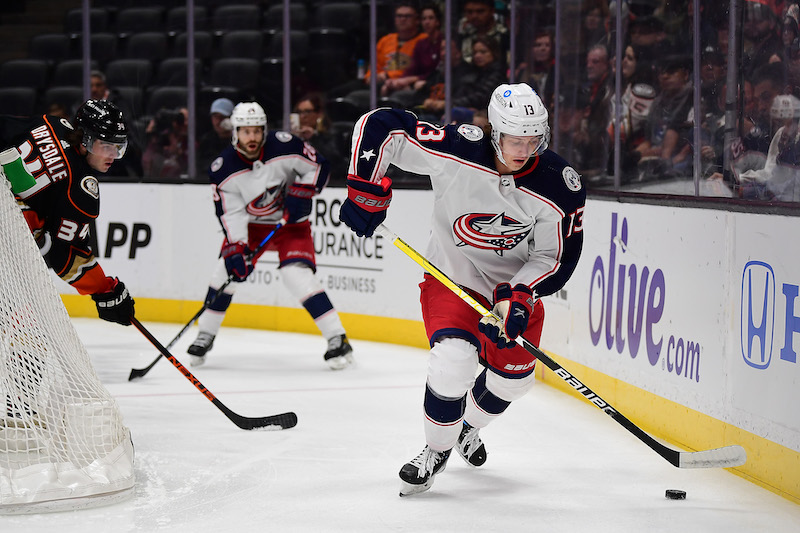 Columbus Blue Jackets' Kent Johnson moves the puck ahead of Anaheim Ducks' Jamie Drysdale during the first period at Honda Center. Columbus Blue Jackets' Kent Johnson moves the puck ahead of Anaheim Ducks' Jamie Drysdale during the first period at Honda Center.
