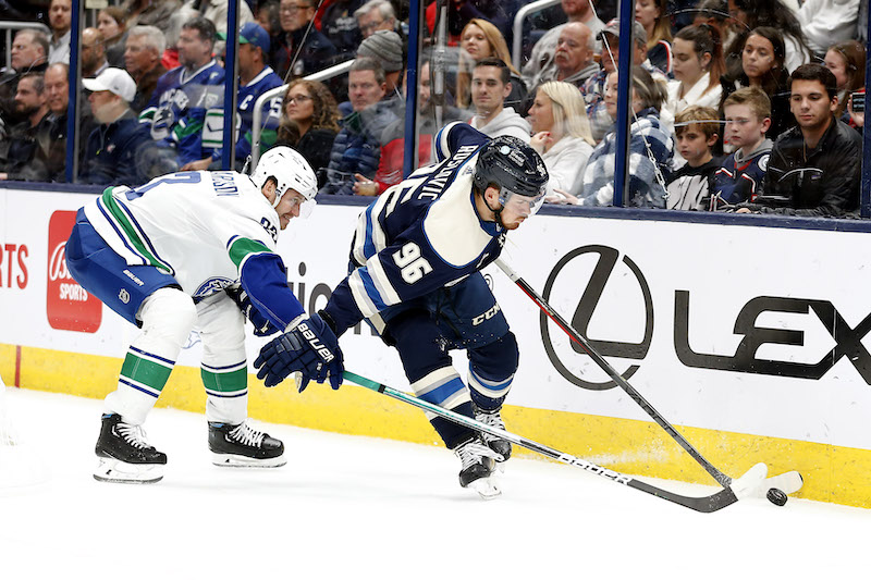 Columbus Blue Jackets' Jack Roslovic skates the puck away from Vancouver Canucks' Oliver Ekman-Larsson during the second period at Nationwide Arena. Columbus Blue Jackets' Jack Roslovic skates the puck away from Vancouver Canucks' Oliver Ekman-Larsson during the second period at Nationwide Arena.