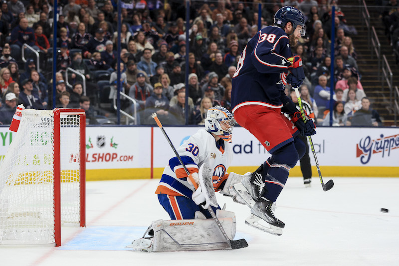 Columbus Blue Jackets' Boone Jenner leaps in the air as Kent Johnson scores a power play goal on a shot against New York Islanders' Ilya Sorokin in the second period at Nationwide Arena.