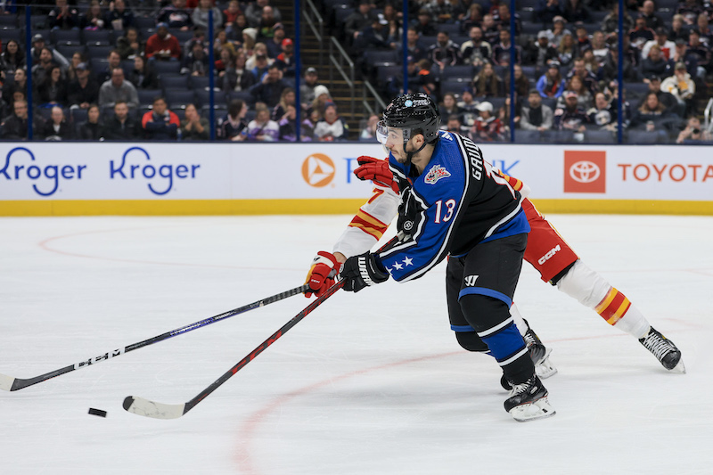 Columbus Blue Jackets' Johnny Gaudreau skates with the puck against Calgary Flames' Tyler Toffoli in the second period at Nationwide Arena.