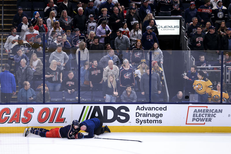Columbus Blue Jackets' Andrew Peeke is tended to by a trainer during a stop in play against the Boston Bruins in the first period at Nationwide Arena. Columbus Blue Jackets' Andrew Peeke is tended to by a trainer during a stop in play against the Boston Bruins in the first period at Nationwide Arena.