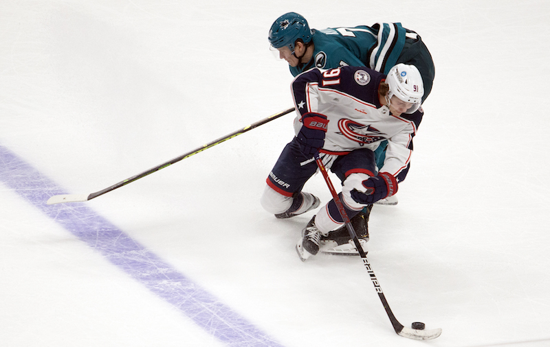 Columbus Blue Jackets' Kent Johnson pivots away from San Jose Sharks' Nikolai Knyzhov during overtime at SAP Center at San Jose.