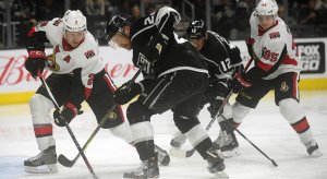 Dion Phaneuf tries to shield away Marian Gaborik during a Senators-Kings game