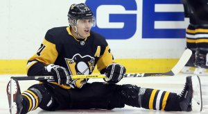 Evgeni Malkin attempts to pick himself up off the ice after falling to the ground.