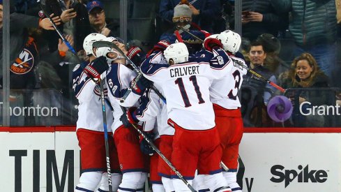 The Columbus Blue Jackets celebrate after scoring the game-winner against the Islanders.