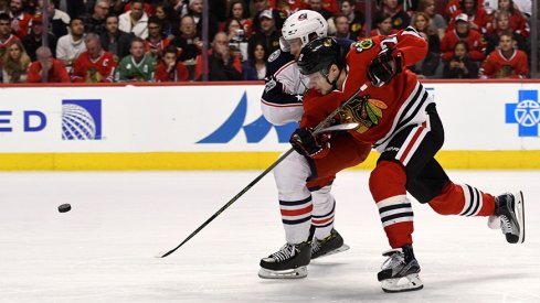 Chicago Blackhawks left wing Artemi Panarin fights for a puck against Columbus Blue Jackets defenseman Seth Jones.