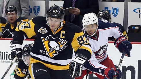 Pittsburgh Penguins center Sidney Crosby (87) chases the puck up ice ahead of right wing Jake Guentzel (59) and Columbus Blue Jackets defenseman Seth Jones (3).