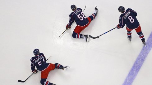 Columbus Blue Jackets defenseman Scott Harrington (54), defenseman David Savard (58), and defenseman Zach Werenski (8).