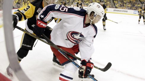 William Karlsson shields the puck away from Olli Maata during Game 1 of the series