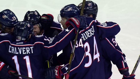 Blue Jackets celebrate a goal against the Penguins.