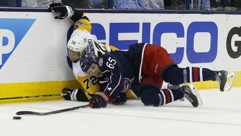 Markus Nutivaara and Patric Hornqvist fight for the puck along the boards