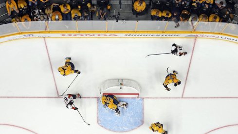 Pekka Rinne attempts to make a save against Richard Rakell