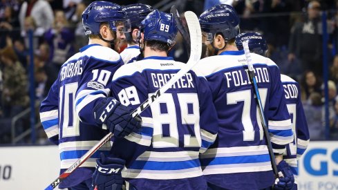 The Blue Jackets celebrate a goal while wearing their third jersey's.