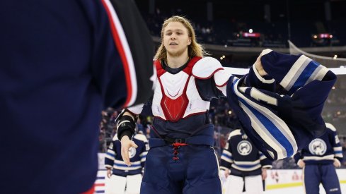 William Karlsson removes his jersey as the team gives their jerseys off of their backs.