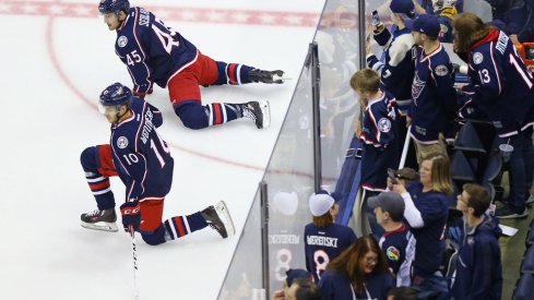 Alexander Wennberg and Lukas Sedlak stretch as fans look on