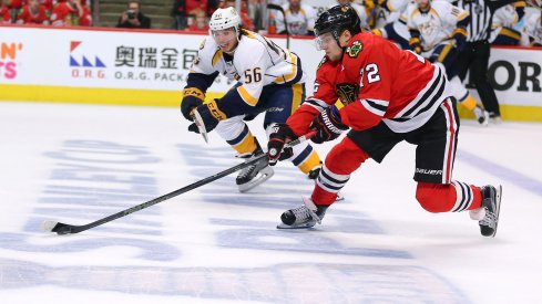 Artemi Panarin skates up the ice with the puck against the Nashville Predators