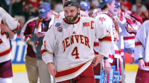 Will Butcher celebrates after the University of Denver won the NCAA National Championship