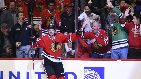 Artemi Panarin celebrates with fans at the United Center