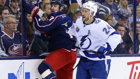 Brandon Dubinsky takes a hit along the boards during the Blue Jackets game against the Tampa Bay Lightning.