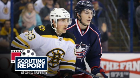 Blue Jackets defenseman Zach Werenski defends Boston Bruins forward Brad Marchand