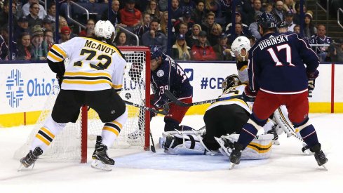 Boone Jenner and Brandon Dubinsky attack the Bruins net