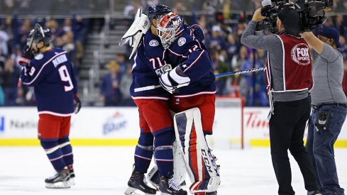 Sergei Bobrovsky and Nick Foligno embrace after a 1-0 overtime win over the Calgary Flames.