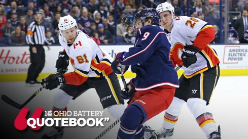 Artemi Panarin fights for the puck with Brett Kulak and Michael Stone chasing him