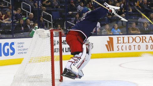 Sergei Bobrovsky jumps in the air to knock a puck down