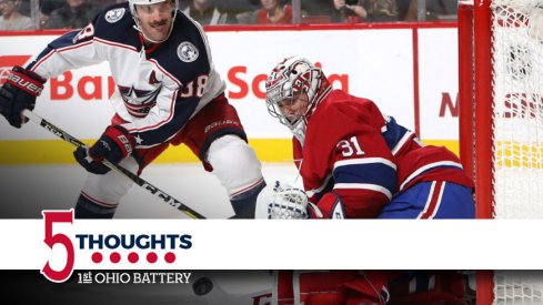 Boone Jenner tries to sneak a puck past goaltender Carey Price