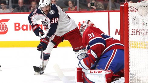 Boone Jenner tries to sneak a puck past goaltender Carey Price
