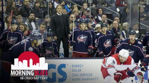John Tortorella stands on the bench to overlook the play that is taking place