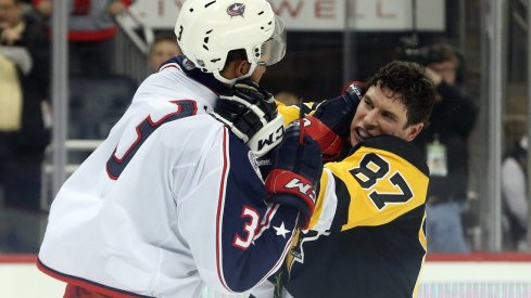 Sidney Crosby and Seth Jones throw punches at one another at the end of the second period.