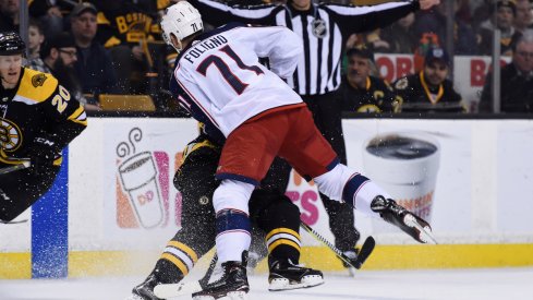 Blue Jackets captain Nick Foligno lays a huge hit on Bruins forward Brad Marchand