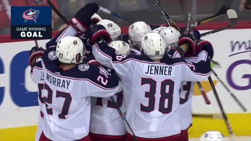 Artemi Panarin is mobbed by his Blue Jackets teammates after scoring the game-winner in overtime.