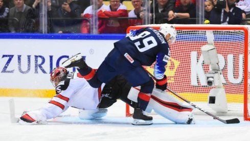 Cam Atkinson sneaks a puck by Darcy Kuemper to help the United States win