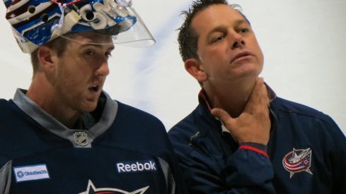 Ian Clark chats with goaltender Jeremy Smith during the Blue Jackets' development camp