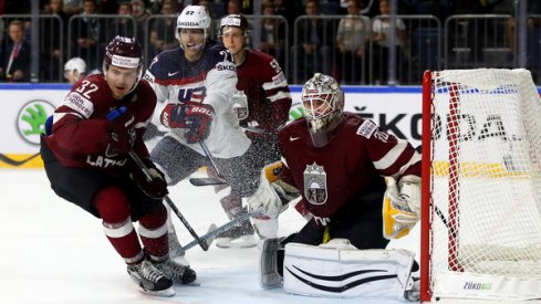 Elvis Merzlikins saves the puck for Latvia against Team USA