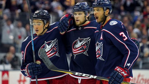 Seth Jones, Josh Anderson and Sonny Milano celebrate a Blue Jackets goal against the Washington Capitals.