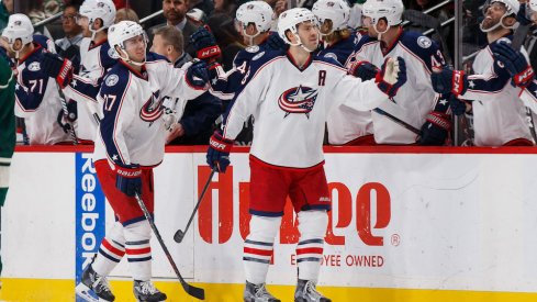 Blue Jackets defenseman Ryan Murray and forward Boone Jenner celebrate a goal with their teammates.