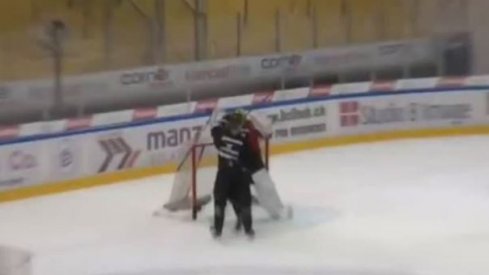 Elvis Merzlikins fights in practice with a fellow HC Lugano teammate