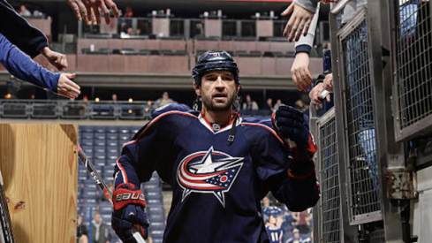 Fedor Tyutin greets fans as he exits the ice after warm-ups at Nationwide Arena.