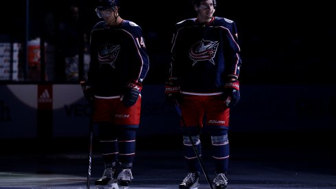 Pierre-Luc Dubois and Dean Kukan wait pregame for the national anthem.