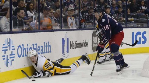Columbus Blue Jackets center Pierre-Luc Dubois chases the puck behind the net in a game against the Pittsburgh Penguins at Nationwide Arena.