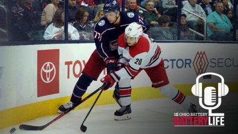 Josh Anderson and Sebastian Aho fight for the puck near the boards as they both try to gain possession