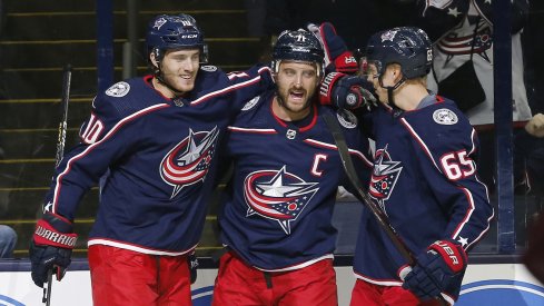 Nick Foligno celebrates his goal with Alexander Wennberg and Markus Nutivaara