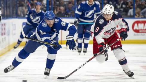 Artemi Panarin attempts to strip the puck from Steven Stamkos.