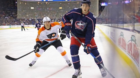 Columbus Blue Jackets defenseman Zach Werenski protects the puck against the Philadelphia Flyers at Nationwide Arena.