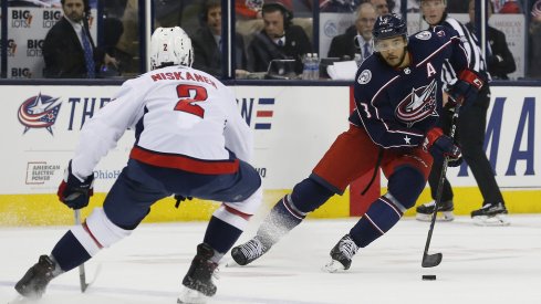 Seth Jones attempts to walk around Capitals defensemen Matt Niskanen