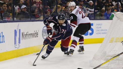 Columbus Blue Jackets captain Nick Foligno protects the puck against Arizona Coyotes defenseman Oliver Ekman-Larsson during a game at Nationwide Arena.